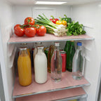 Transparent fridge mats protecting multiple refrigerator shelves from food stains