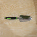 Garden tool in use for planting in flower bed