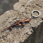 Side view of metal gun-shaped keychain accessory