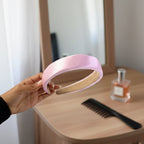 Smiling woman wearing the comfortable padded satin hairband