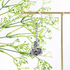 Angled view highlighting silver finish on Bal Krishna Makhan Chor metal keychain