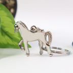 Metallic horse keychain size comparison with Indian currency note