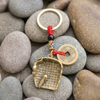 Feng shui lucky coin charm on red braided cord