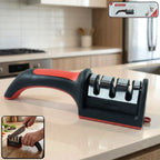 Red and black 3-stage manual knife sharpener for home kitchen use.