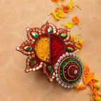Close-up of the sparkling stone work on the lid of kumkum dani.