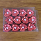 Heart shaped decorative LED tea light candles glowing softly at night