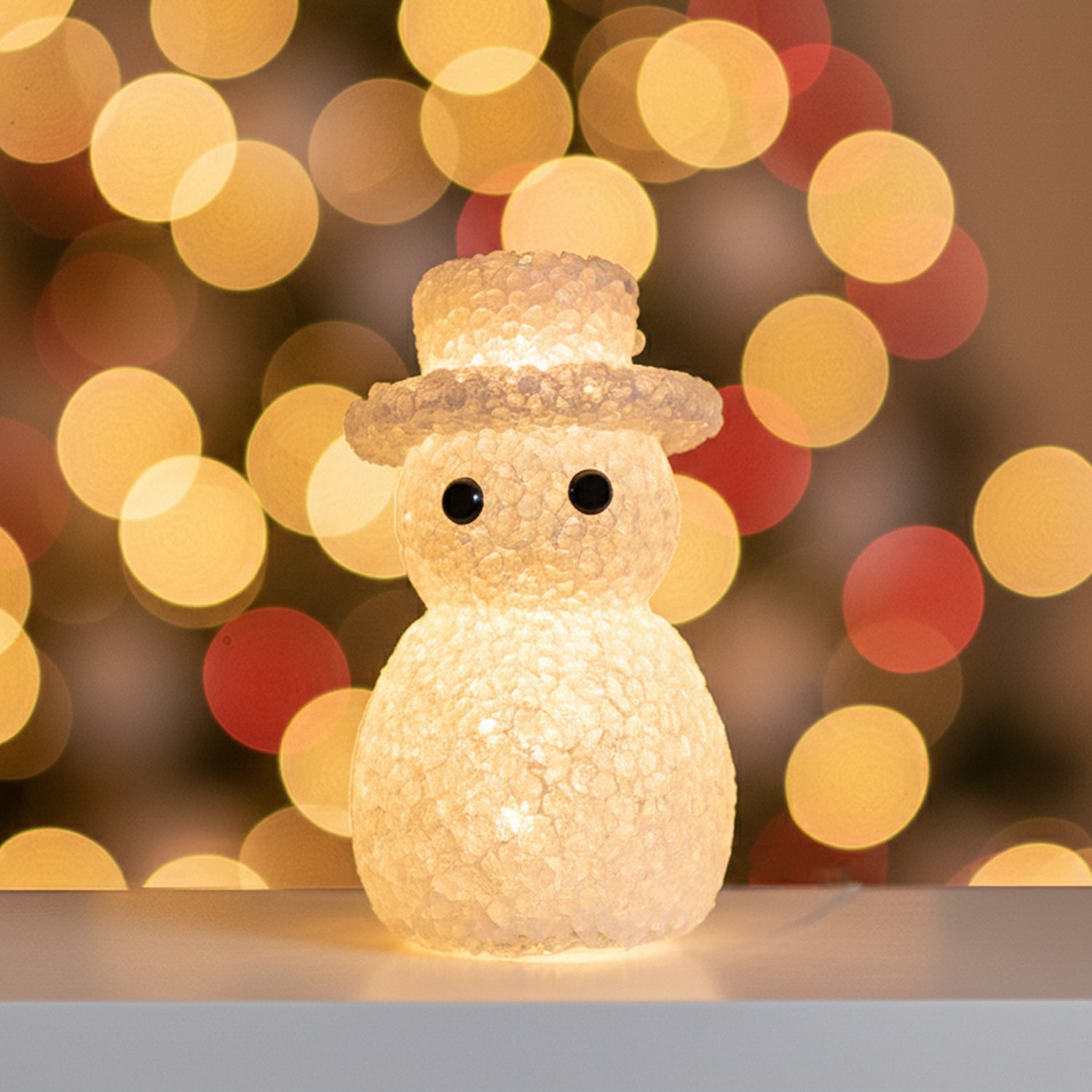 Snowman LED table lamp emitting soft glow perfect for holiday decor