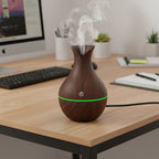 Close-up of the Mini Wooden Humidifier highlighting its LED light and mist output.