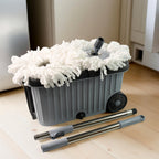 Spin mop system on wheels with dual chamber bucket for efficient cleaning