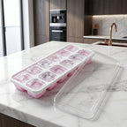Side view of pink ice cube tray with lid