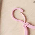 Folded clothes hanger fitting in travel bag pocket for space-saving
