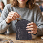 Stylish black leather mini pouch fitted into a pocket or handbag.