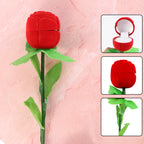 Closed artificial rose ring box gift with flower bud concealing a secure ring holder inside