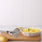 Close-up of stainless steel potato masher with sturdy design
