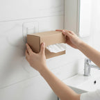 Transparent adhesive wall hook securely mounted in a modern bathroom setting.