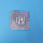 Transparent double sided self adhesive wall hook in use.