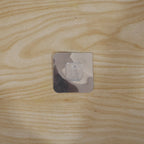 Self adhesive wall hook securely holding items in a home setting.