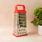 Compact stainless steel kitchen grater and slicer tool with secure base