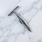 Stainless steel coconut breaker tool set displayed on a white background