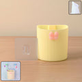 Wall-mounted toothbrush holder with butterfly design on a bathroom wall