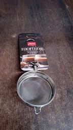 Stainless steel tea strainer positioned within a kitchen setting
