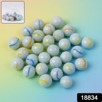 Net pouch containing classic white glass marbles with colorful swirls