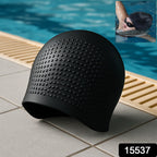 Swimmer wearing silicone swimming cap in pool water