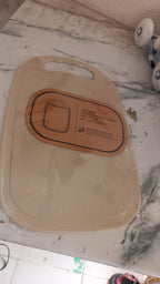 Hand holding lightweight plastic chopping board with handle