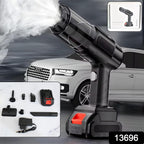 Compact portable vacuum cleaner being used to clean car interior, highlighting its cordless design.