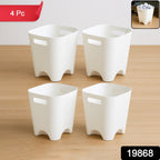 Plastic waste paper basket set used in a clean, modern home office setting.