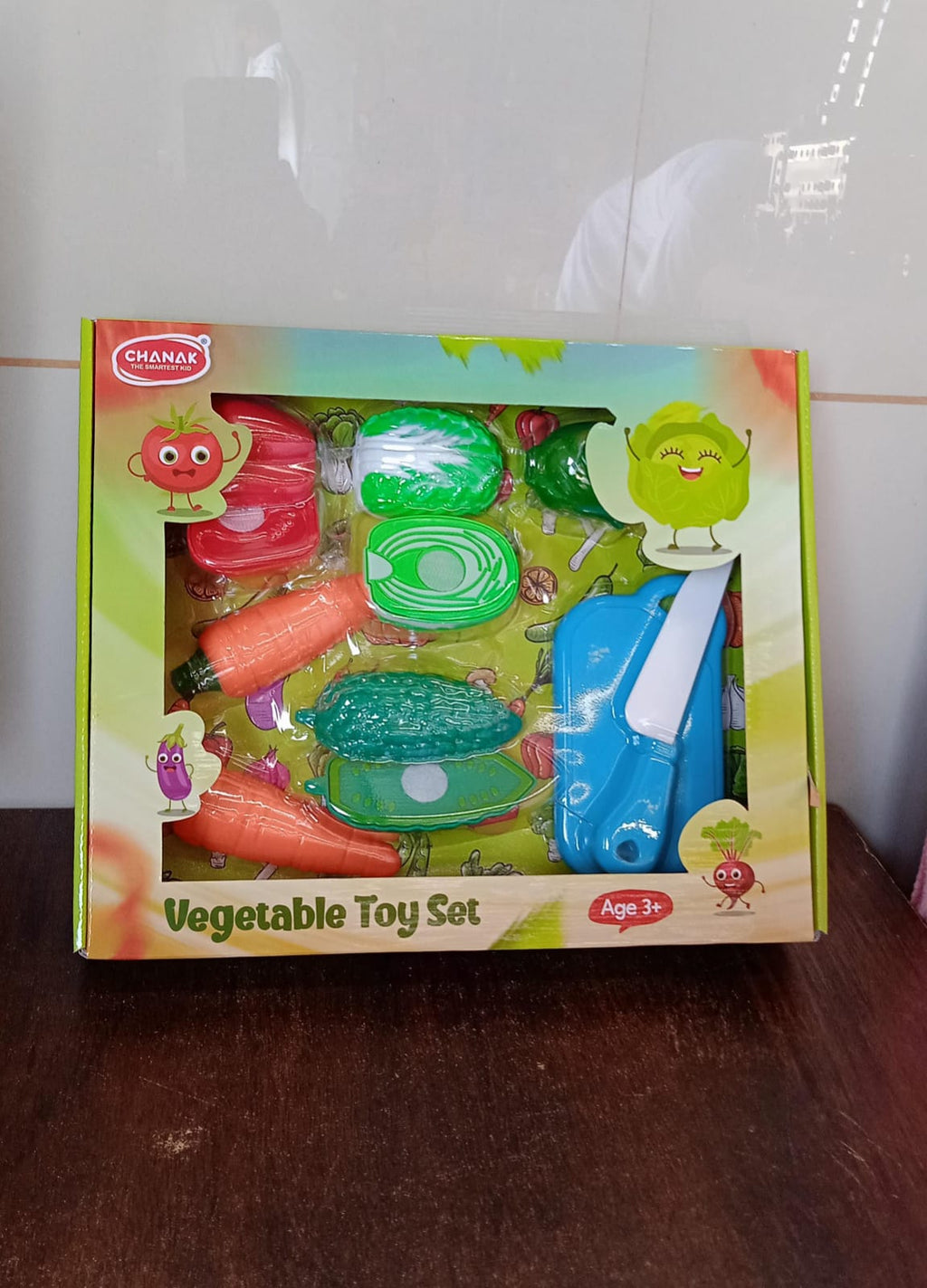 Toy corn, onion, and eggplant pieces, perfectly sliced into two halves for play.