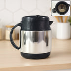 Side view of insulated thermos flask accompanied by ceramic cups for tea and coffee