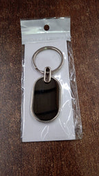 Dual tone black and silver oval keychain accessory for keys and bags