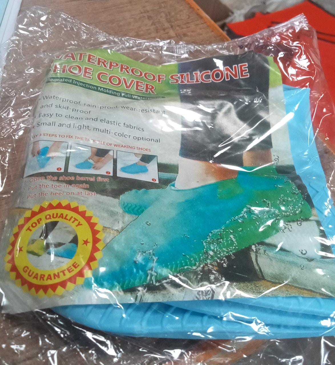 A clear plastic package for waterproof silicone shoe covers, displaying product features and images of the blue covers.