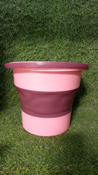 The compact foldable water bucket neatly collapsed for easy storage.