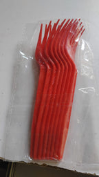 Close-up focus on red plastic disposable forks for party use