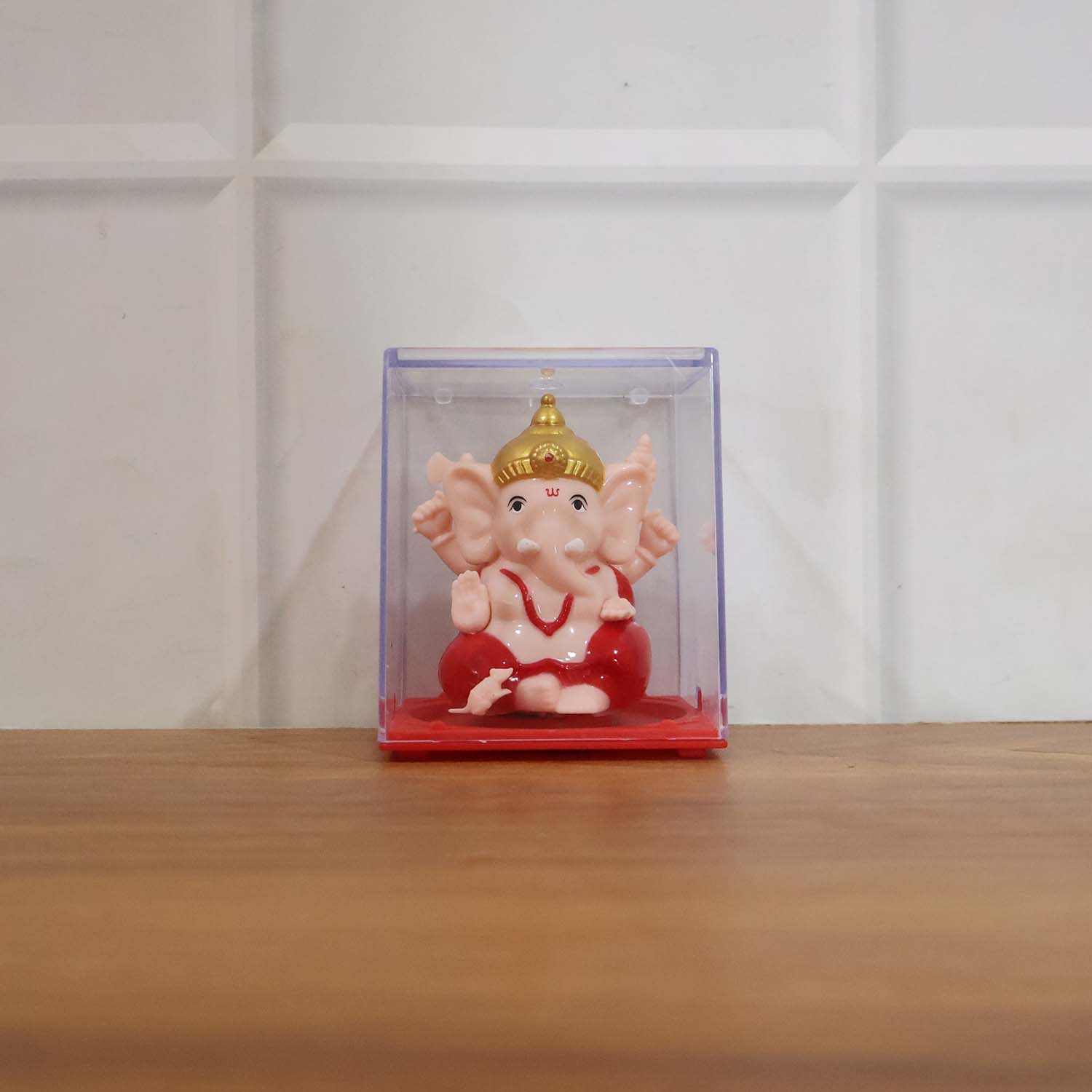 Back view of small red and gold Ganesha decorative statue