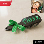Cute printed kids hair brush featuring a ribbon bow handle, ideal for daily grooming.