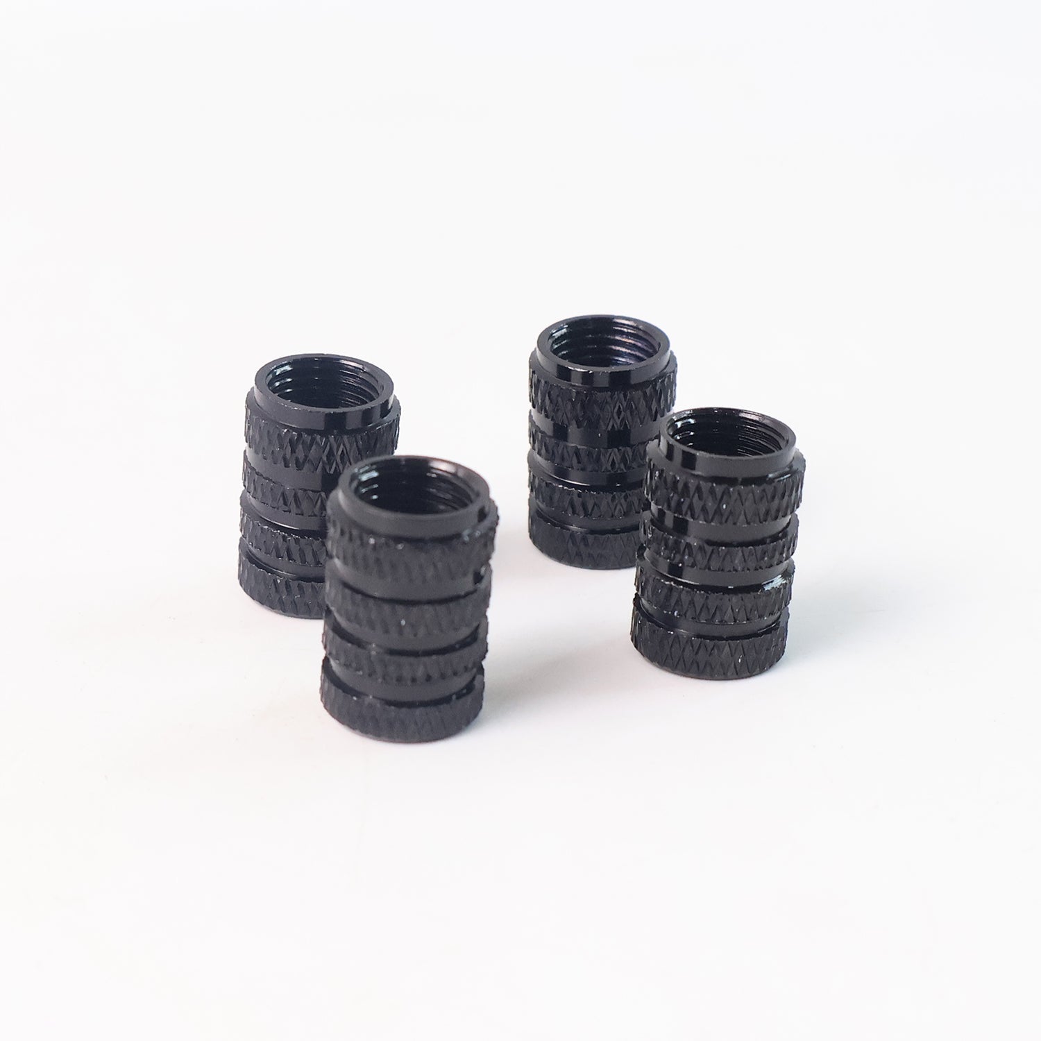 A single silver aluminium tire valve stem cap placed on a clean white background.