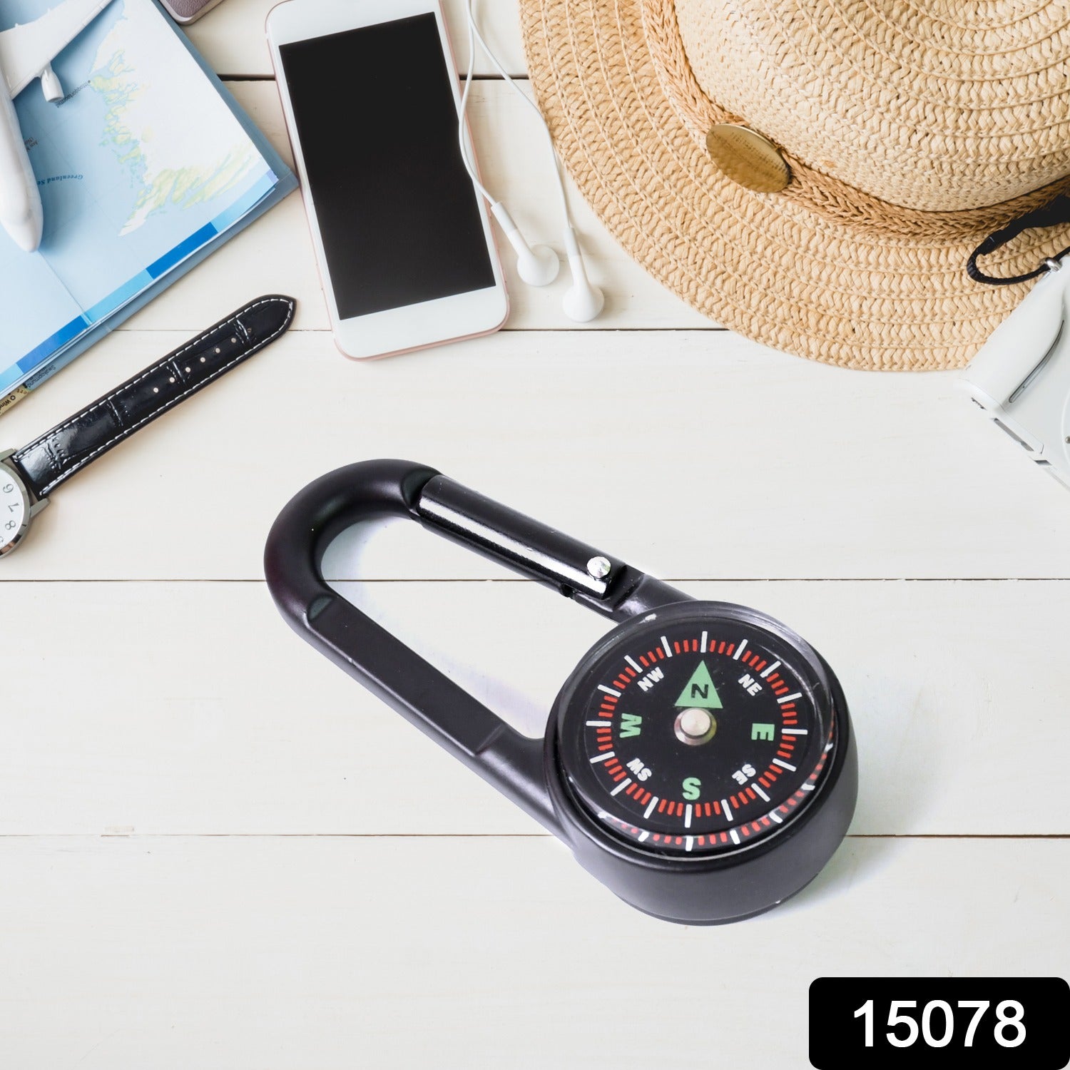 Close-up of the mini compass with clip, highlighting the clear dial and durable snap hook.