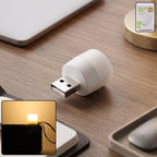 Yellow USB LED night light plugged into a USB port illuminating warm ambient glow